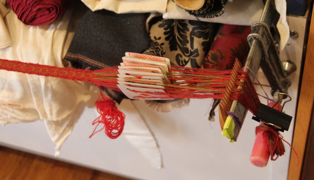 Weaving loom using G clamp, comb and playing cards strung with wool thread
