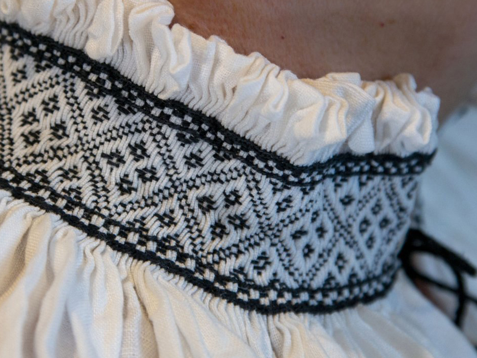 Collar of a pleated smock, with elaborate embroidery, worked over the pleats