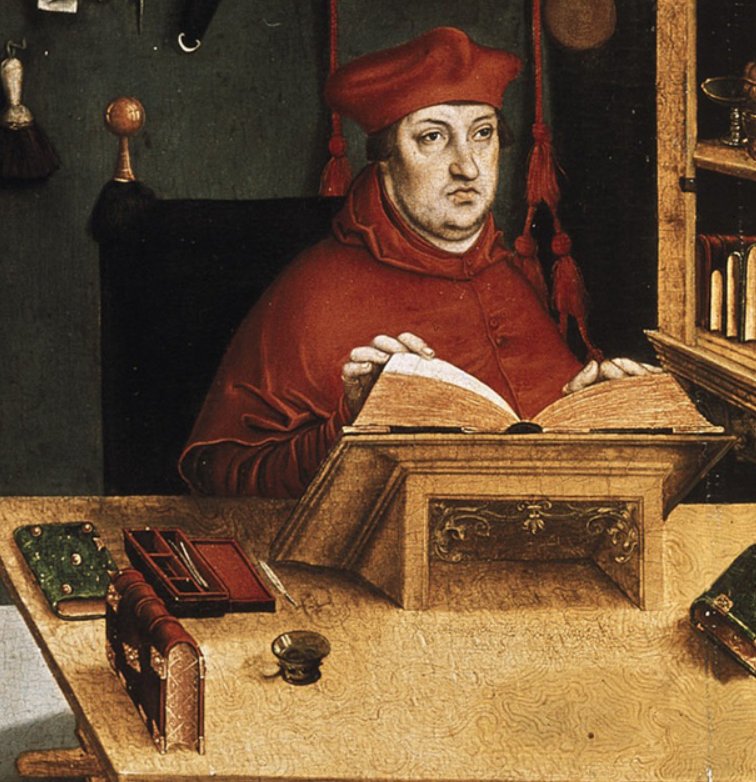 Painting of medieval cardinal seated at desk, with books and rectangular box with pens in it