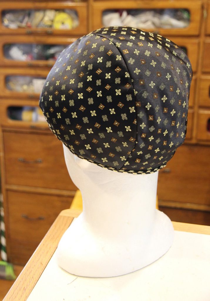 Headform with patterned silk cap