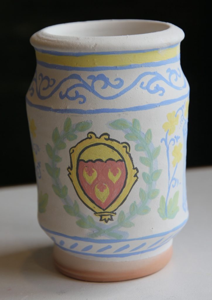 Ceramic jar with heraldic device in unfired glaze