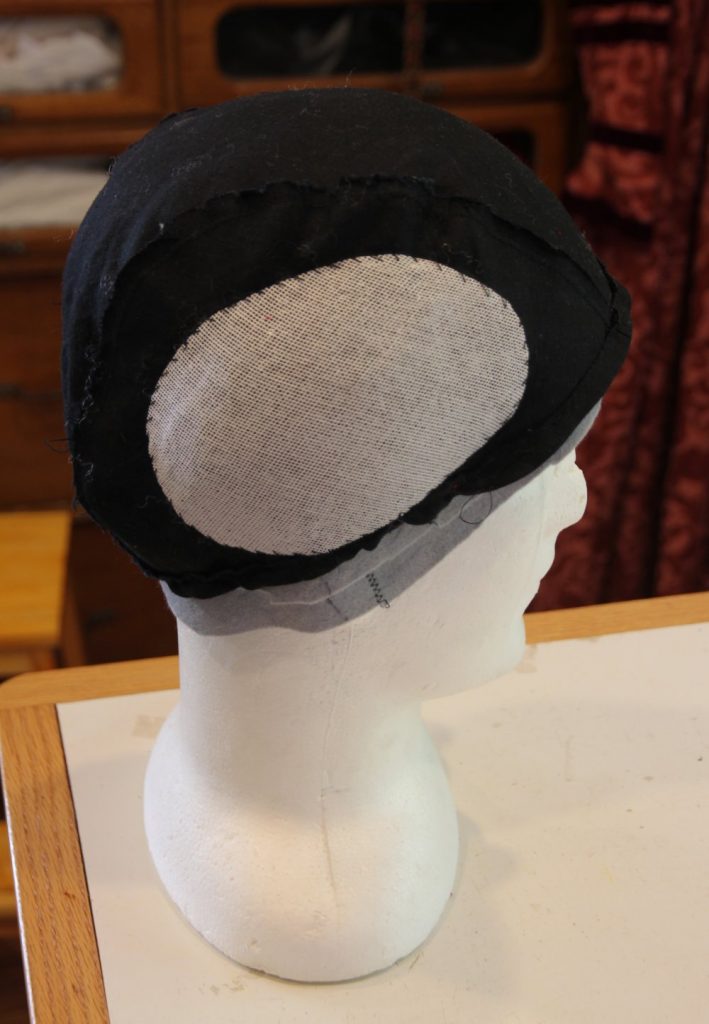 Headform with cap lining, with puffed out pieces sewn to sides