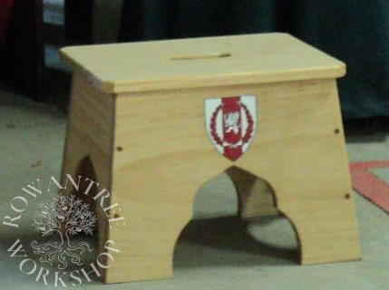 Rectangular boarded stool with painted heraldic shild