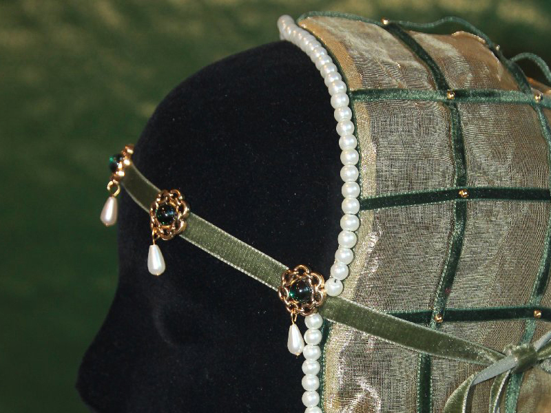 Cap of gold gauze, decorated with velvet ribbons and pearls