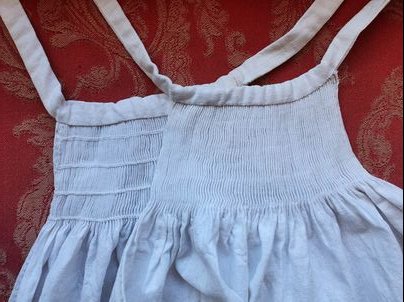 Top portion of a double-apron, with fine smocking and shoulder straps