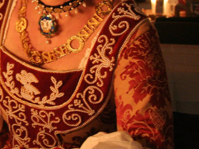 Torso of a woman wearing a brocade German gown, decorated with an elaborate design in pearls