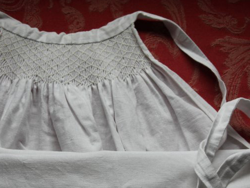 Top section of an apron with a deep section of fine smocking