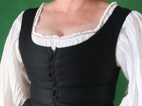 Torso of a woman wearing a sleeveless dress with tight front lacing