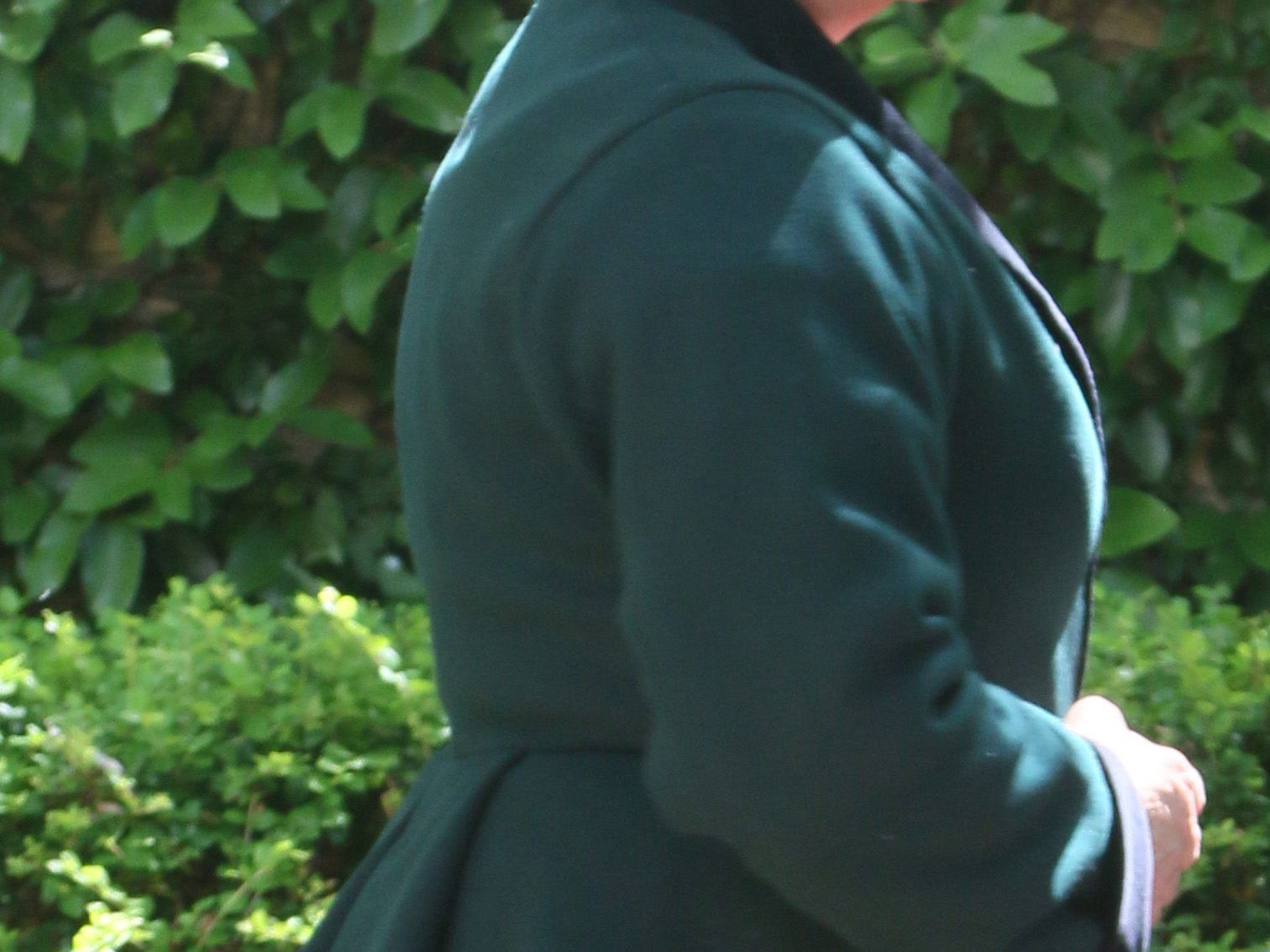 Woman's torso wearing a heavy wool jacket with back pleat