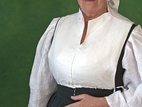 Woman wearing a linen partlet, tied over her underdress