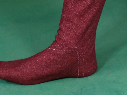 Foot in woollen hose, with M shaped seam over the instep