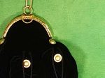 Part of a black velvet purse with rounded gold frame