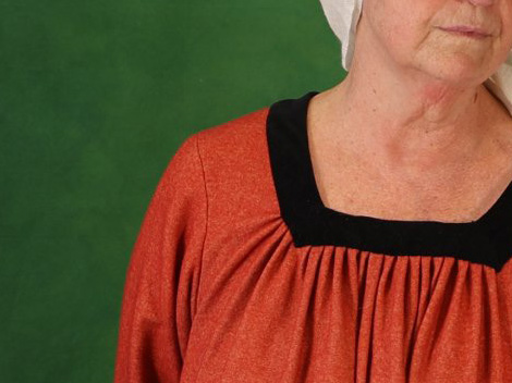 Woman's shoulder with pleated woolen gown