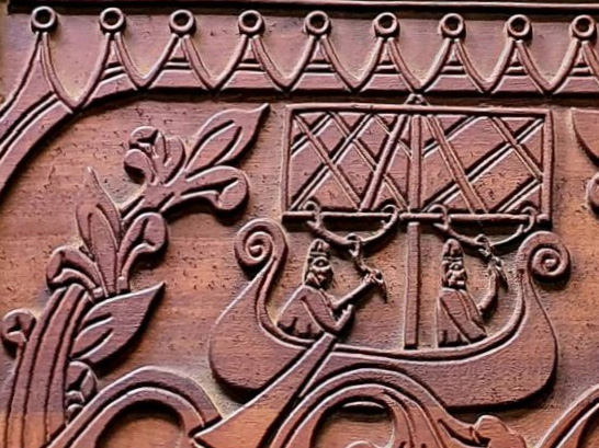 Carved wooden panel depicting a Norse sailing ship