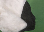 Black foam head wearing a white fur cap with side folds